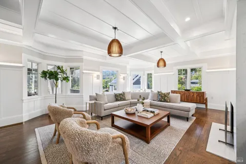 a kitchen with kitchen island a wooden floor and white appliances