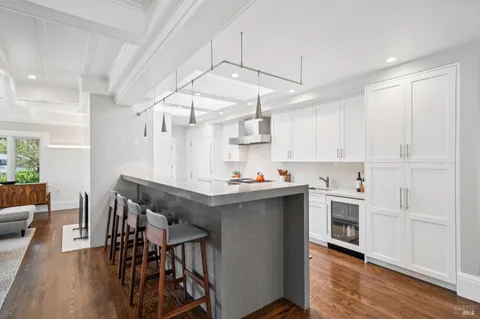 a view of a kitchen with stainless steel appliances a sink and cabinets
