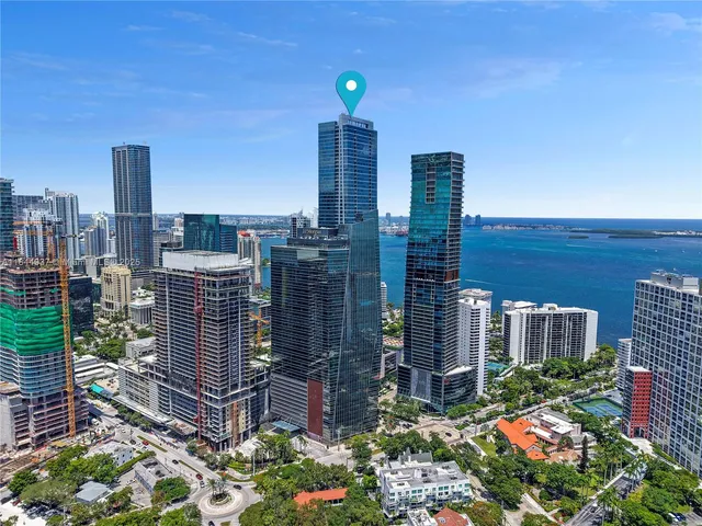 a living room with furniture and floor to ceiling windows