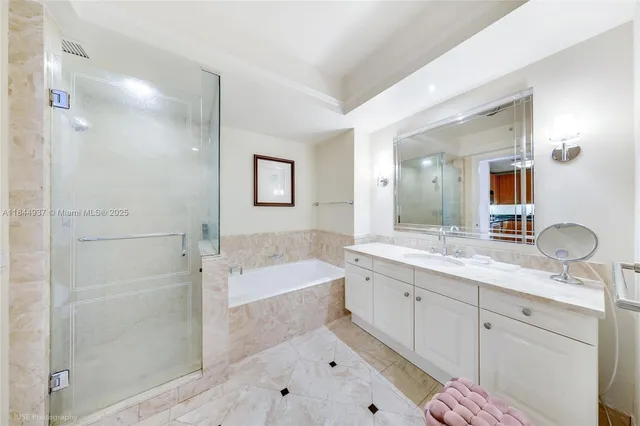 a bathroom with a tub sink and mirror