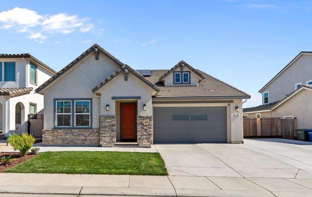 a front view of a house with a garden