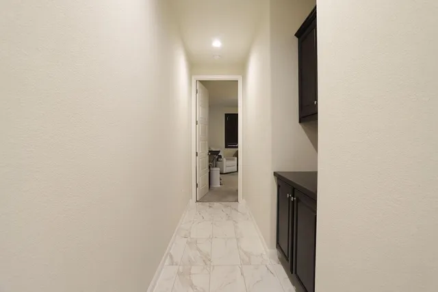 a bedroom with a bed a table and windows