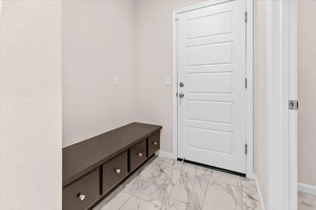 a spacious bathroom with a toilet sink and a mirror