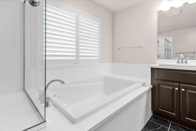 a view of walk in closet with clothes