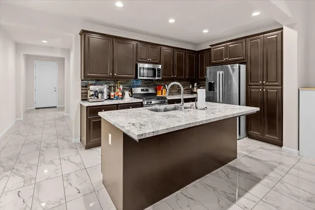 a living room with dining room and couches