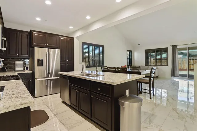 a kitchen with stainless steel appliances a stove sink microwave and cabinets