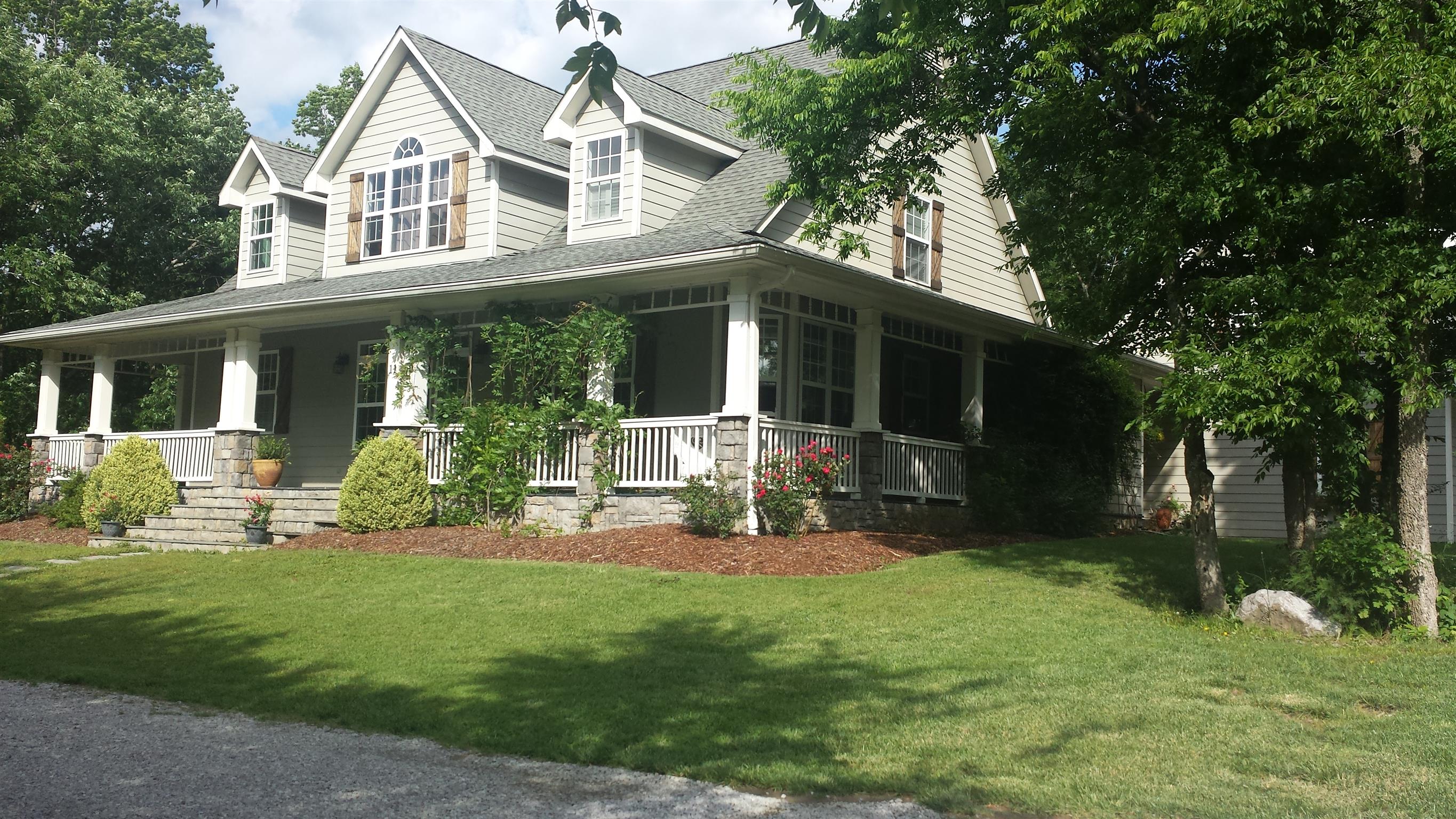 a view of a house with a yard and sitting area