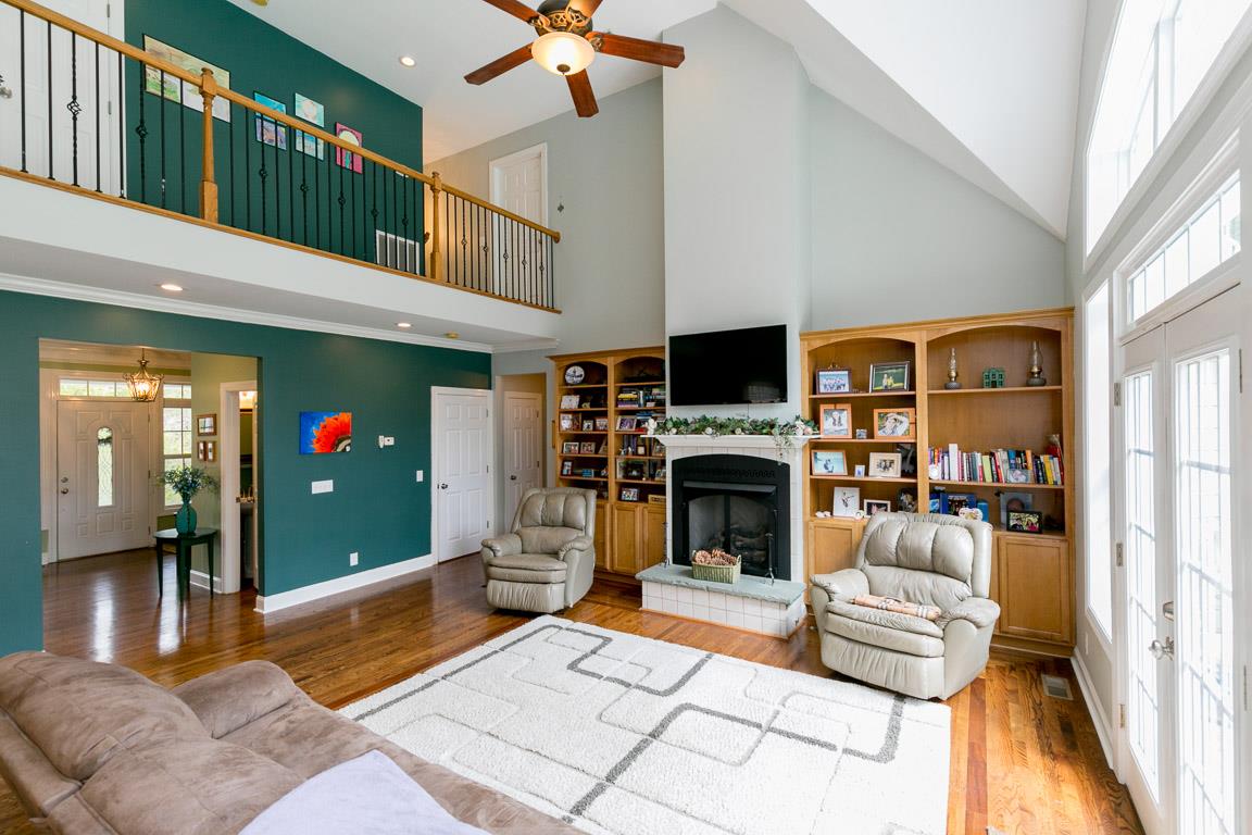 1160 Waller Road Brentwood, TN 37027 - Photo 4 of 28 a living room with furniture a flat screen tv and a fireplace