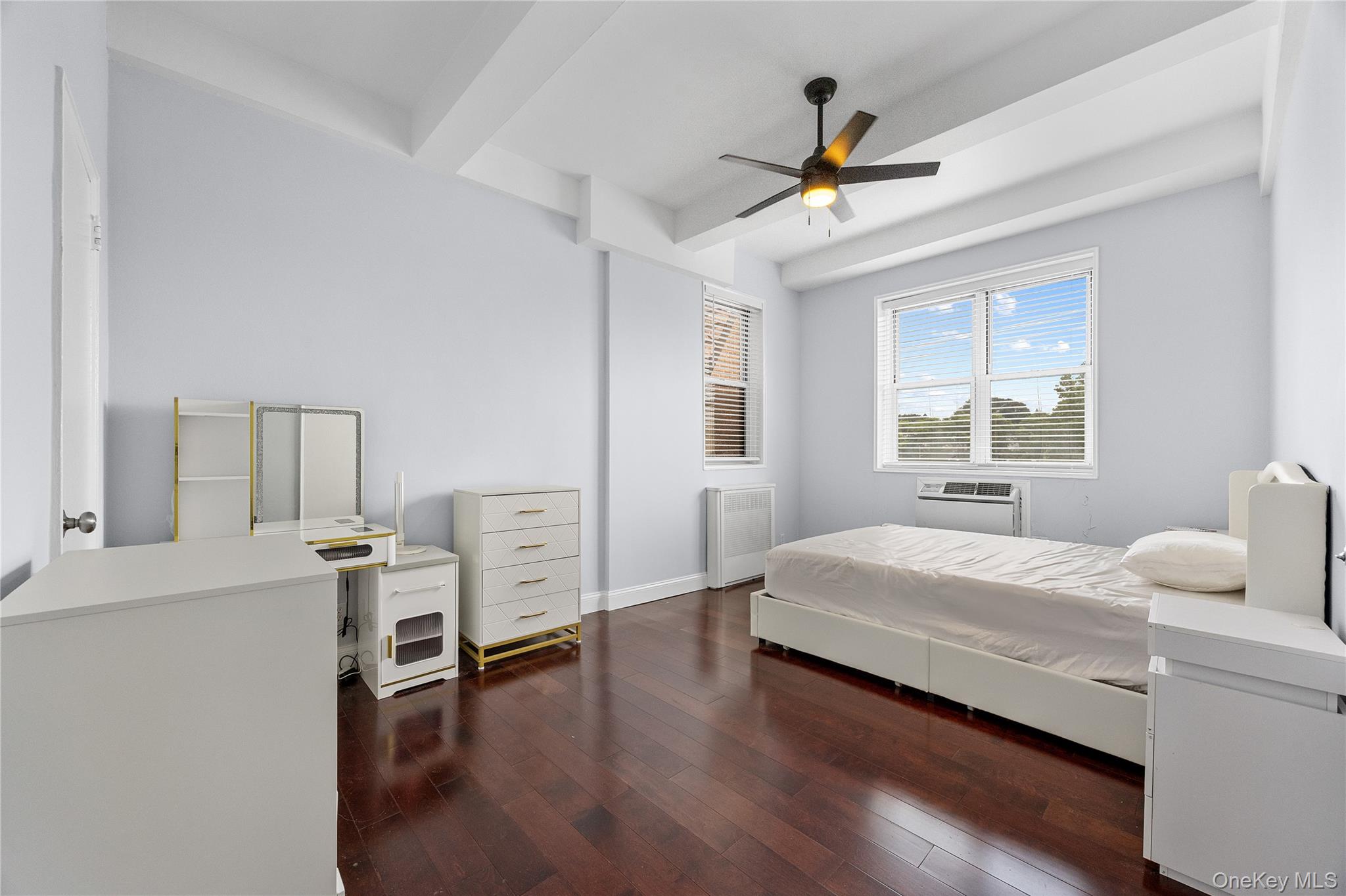355 Bronx River Road, Unit 1I Yonkers, NY 10704 - Photo 11 of 22 Bedroom with beam ceiling, radiator heating unit, hardwood / wood-style floors, and ceiling fan