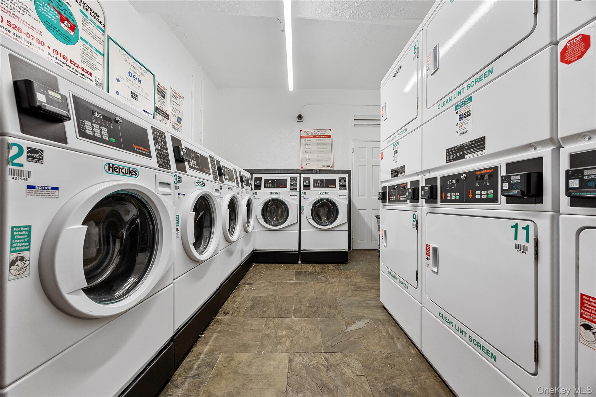 355 Bronx River Road, Unit 1I Yonkers, NY 10704 - Photo 14 of 22 Shared laundry room featuring stacked washer / dryer, washing machine and clothes dryer, and stone finish flooring
