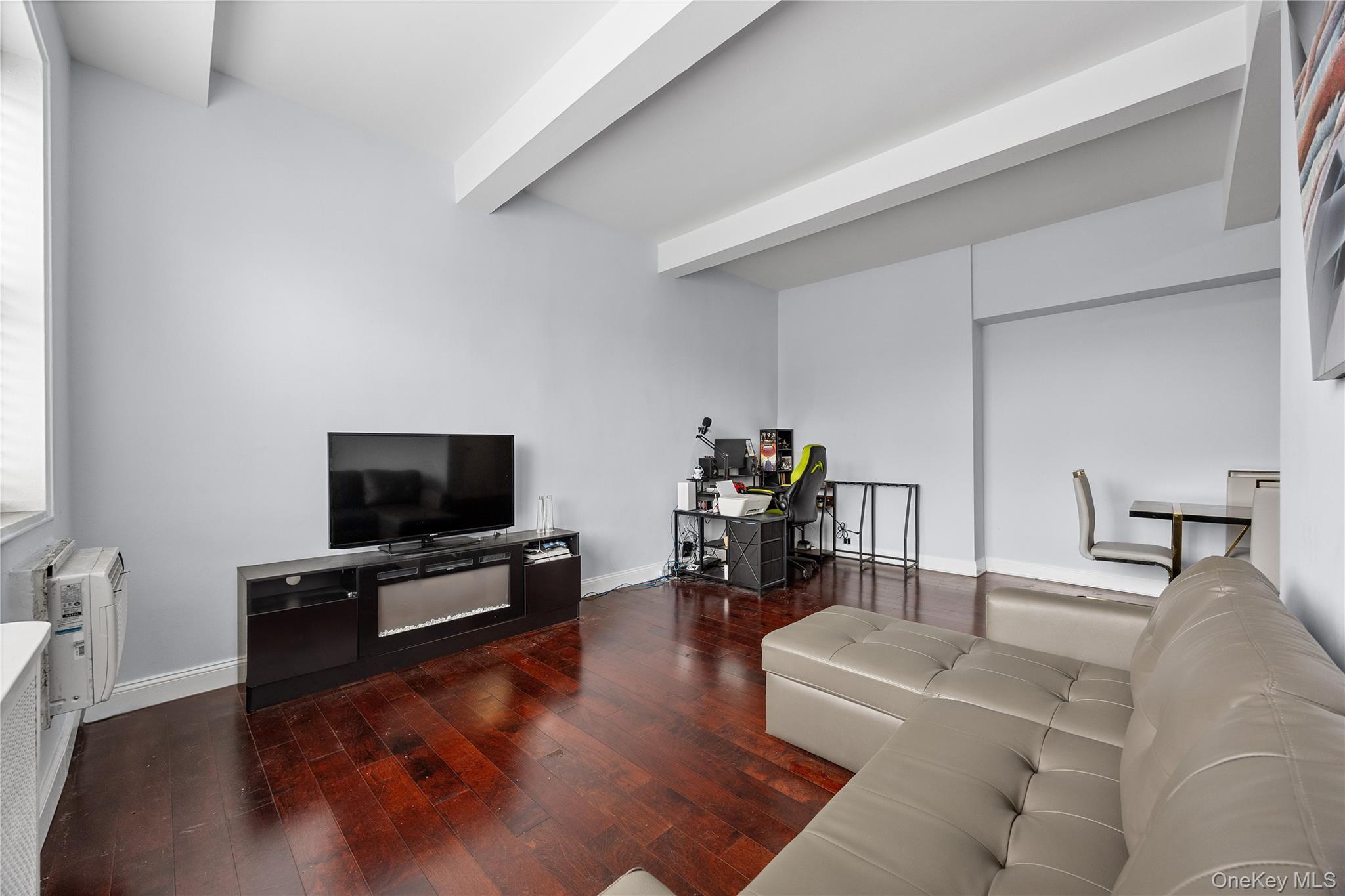 355 Bronx River Road, Unit 1I Yonkers, NY 10704 - Photo 4 of 22 Living area featuring wood-type flooring and beamed ceiling