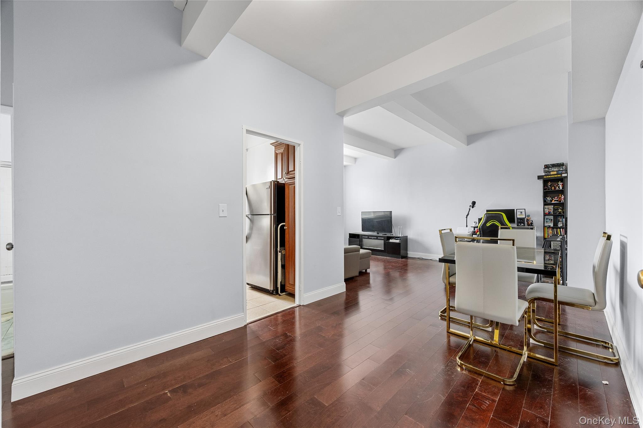 355 Bronx River Road, Unit 1I Yonkers, NY 10704 - Photo 7 of 22 Dining area with wood finished floors, beam ceiling, and an office area
