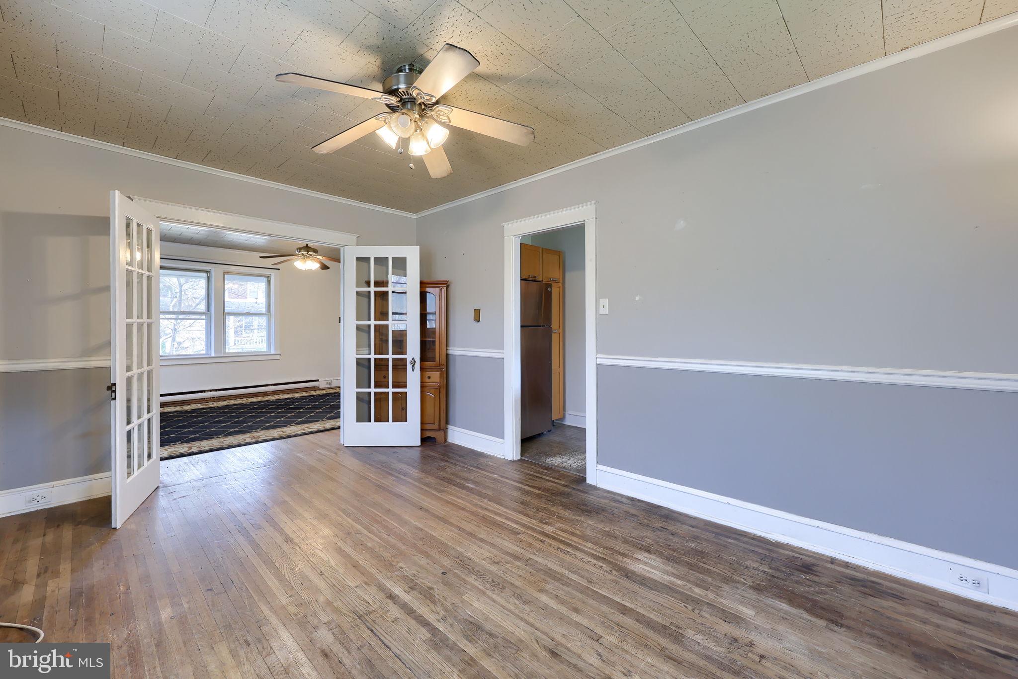 836 3rd Street Lancaster, PA 17603 - Photo 11 of 30 an empty room with wooden floor chandelier fan and windows