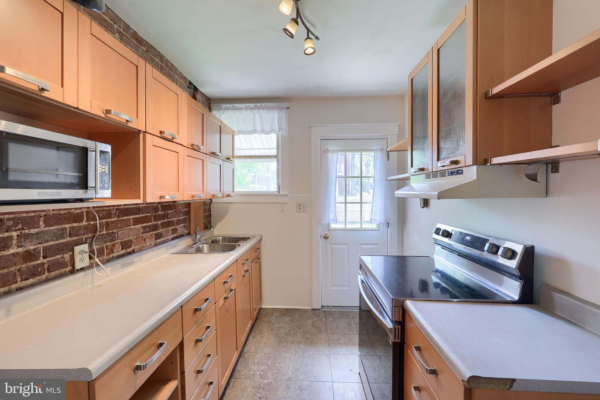 836 3rd Street Lancaster, PA 17603 - Photo 13 of 30 a kitchen with stainless steel appliances a stove a sink and a microwave
