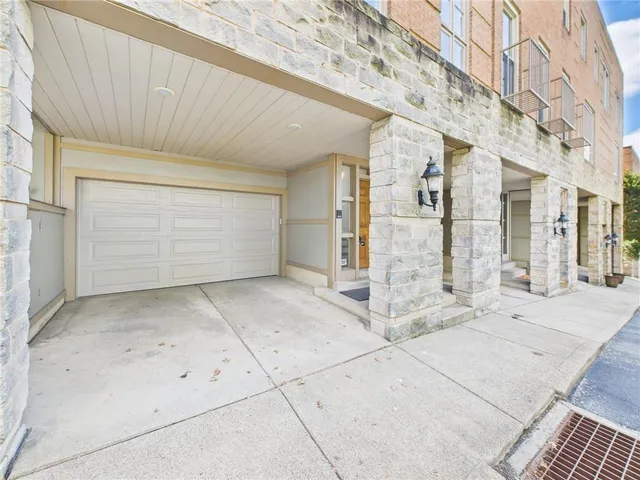 a view of a brick house with parking space