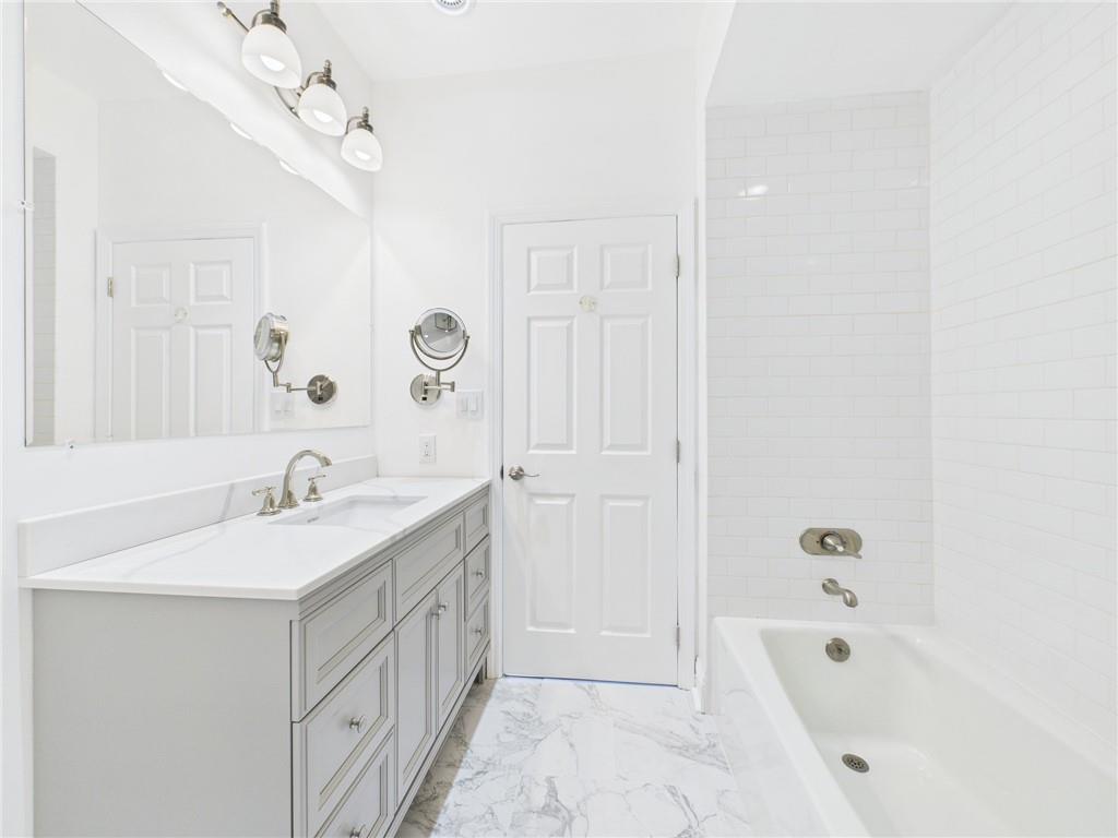 138 North Woodland Road Pittsburgh, PA 15232 - Photo 17 of 50 a bathroom with a double vanity sink a mirror and a bathtub