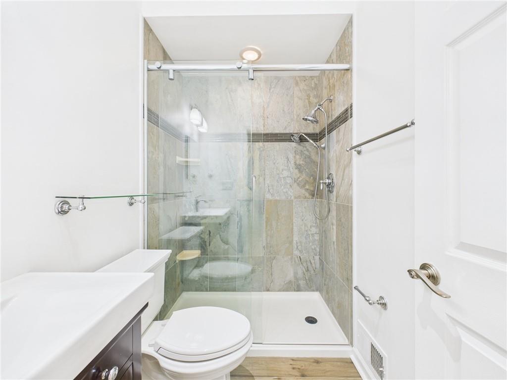 138 North Woodland Road Pittsburgh, PA 15232 - Photo 22 of 50 a white toilet sitting next to a bath tub and a shower