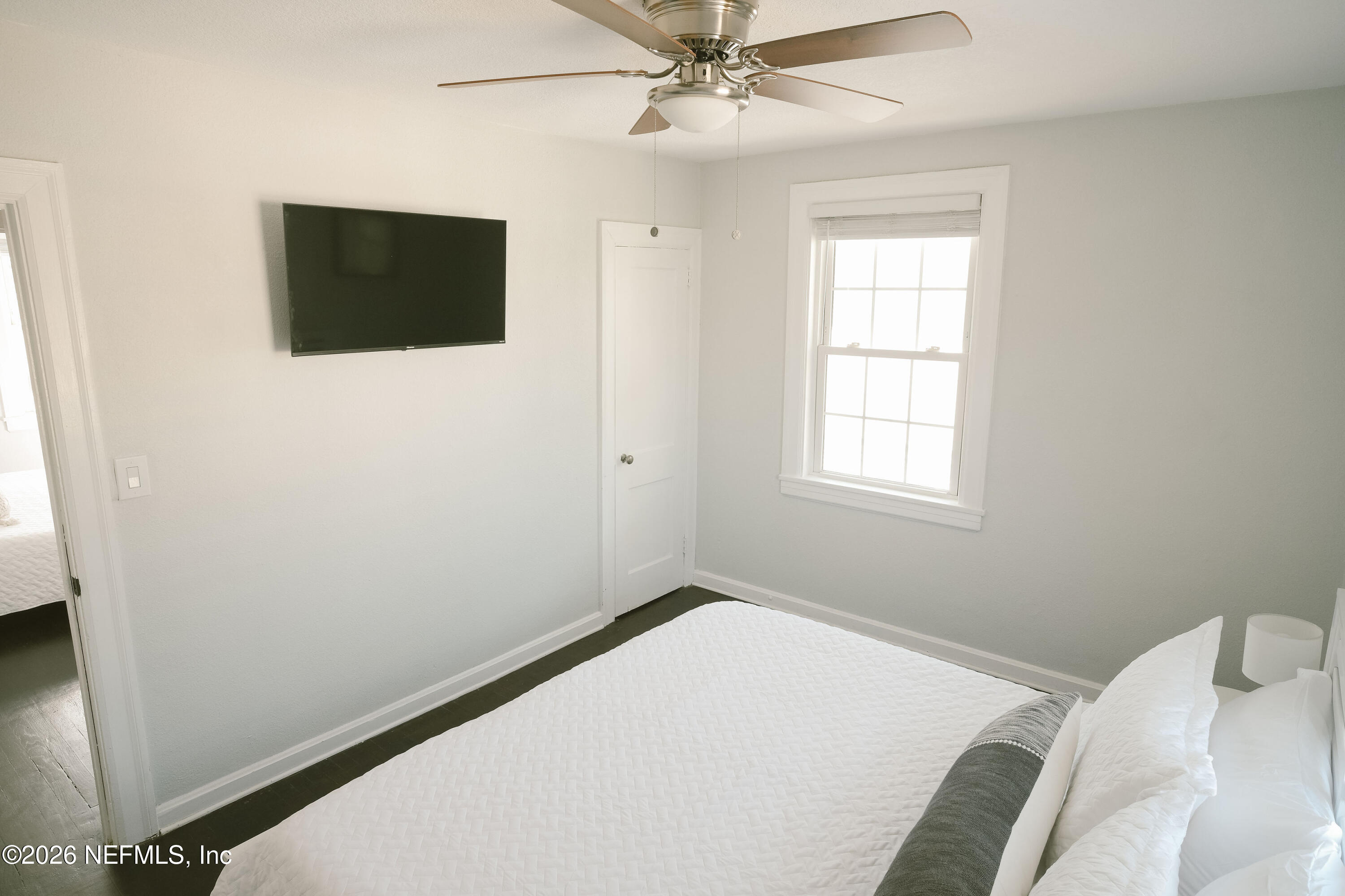 212 Oak Street Neptune Beach, FL 32266 - Photo 16 of 43 a bedroom with a bed and a flat screen tv