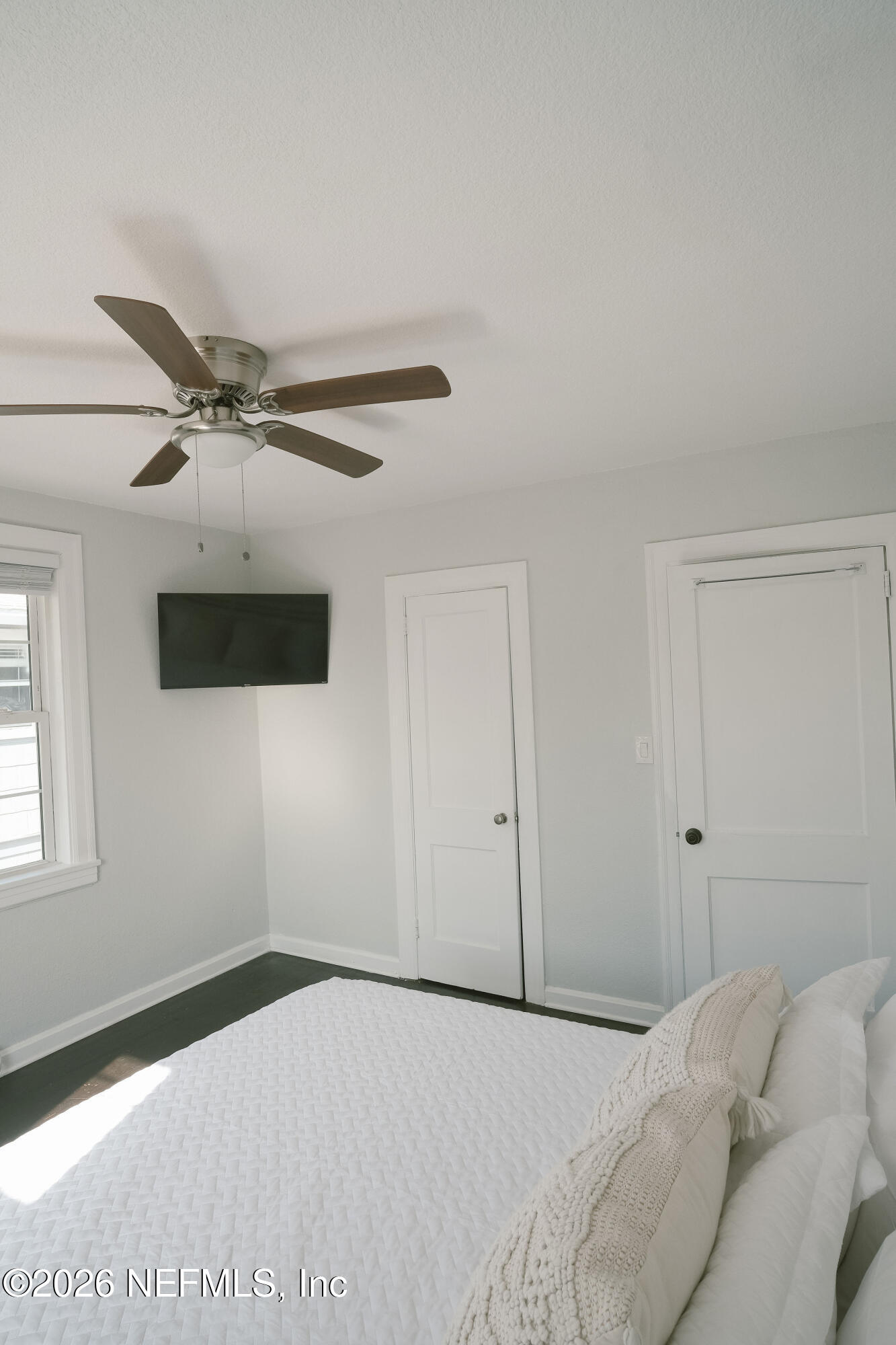 212 Oak Street Neptune Beach, FL 32266 - Photo 28 of 43 a bedroom with a bed and a ceiling fan