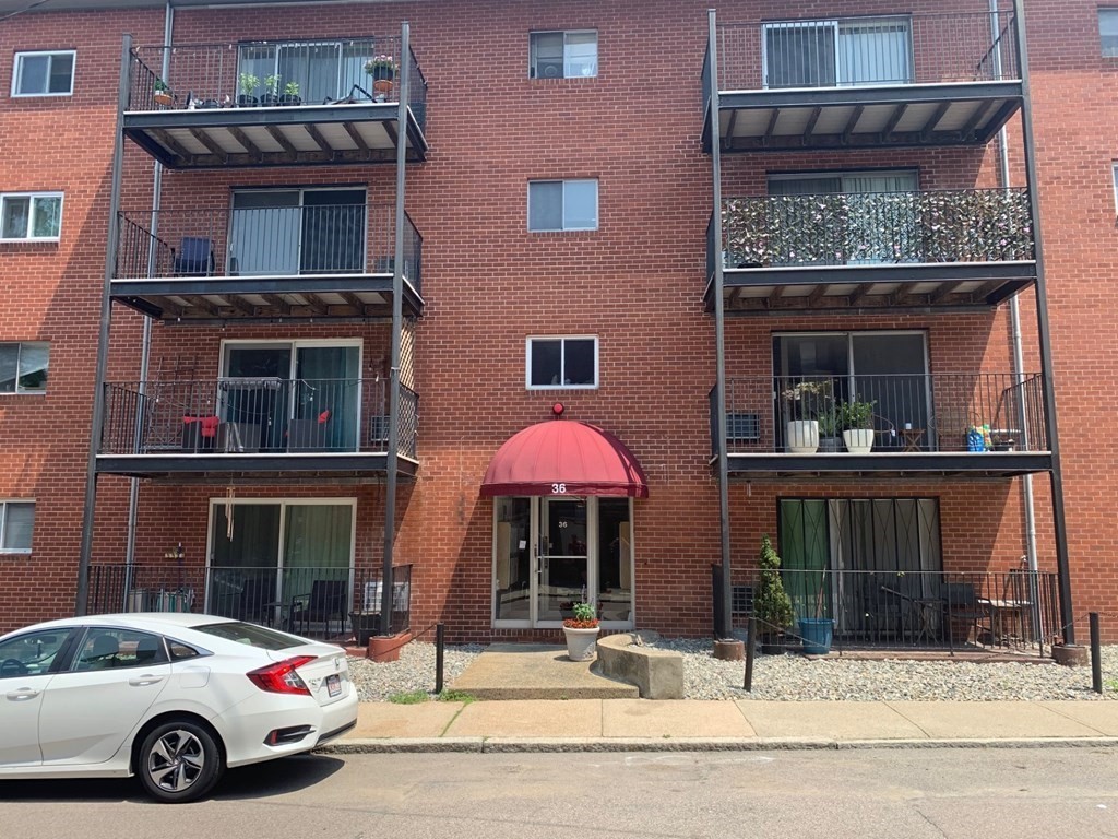 a front view of a house with parking space