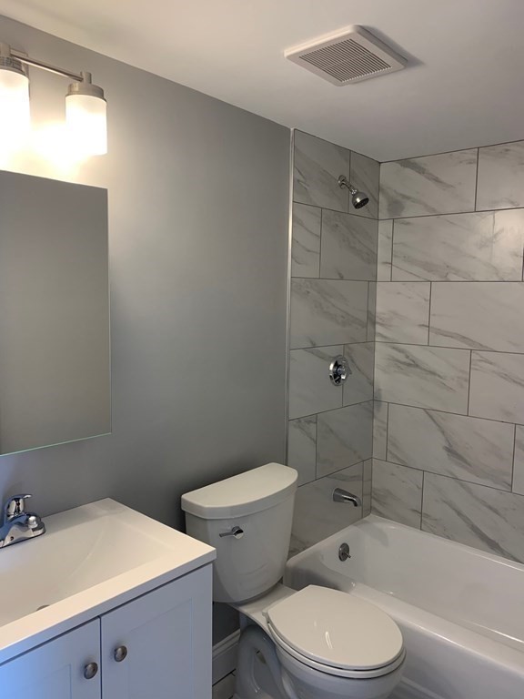 36 Bellvista Road, Unit 47 Boston, MA 02135 - Photo 4 of 12 a bathroom with a sink a toilet and shower