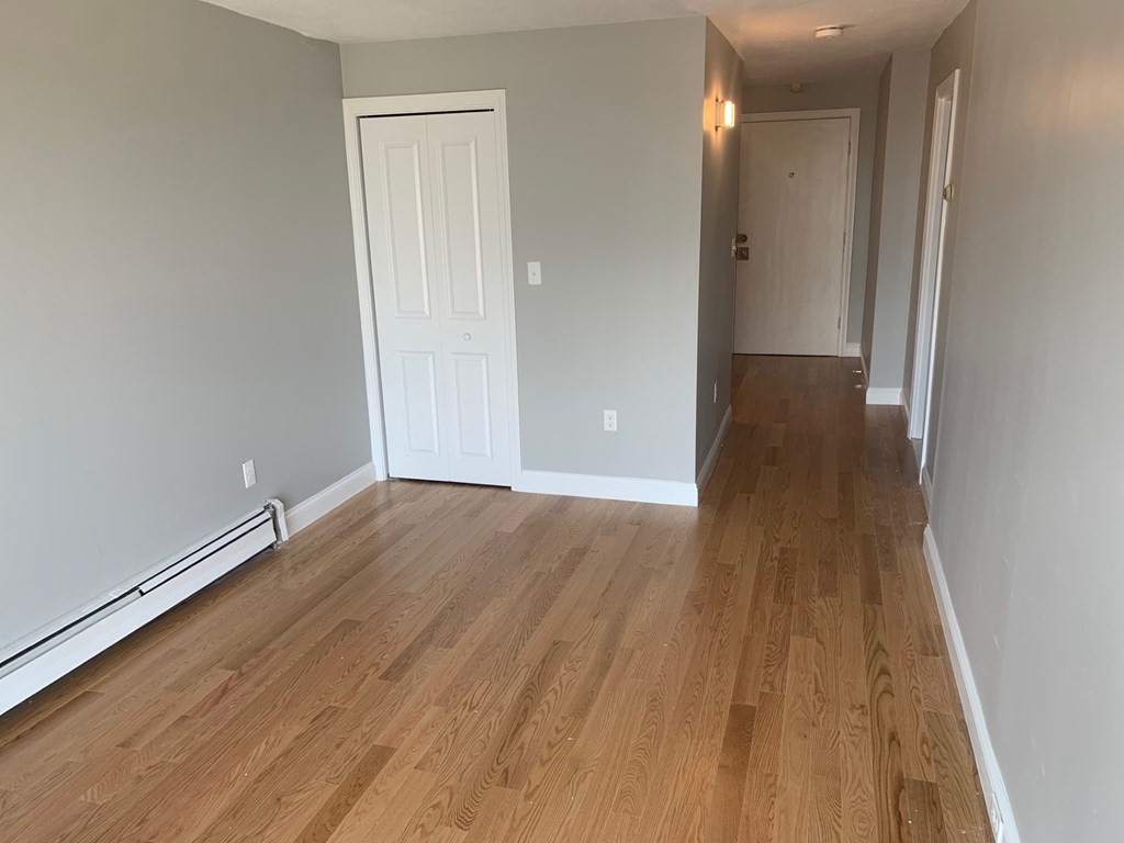 36 Bellvista Road, Unit 47 Boston, MA 02135 - Photo 6 of 12 wooden floor in an empty room with a window
