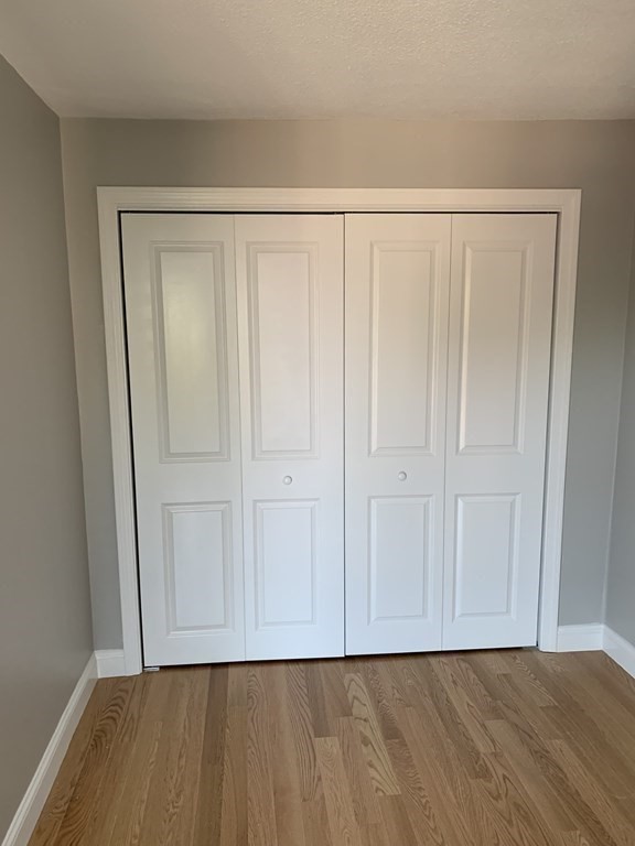 36 Bellvista Road, Unit 47 Boston, MA 02135 - Photo 7 of 12 a view of an empty room with wooden floor