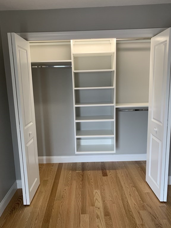 36 Bellvista Road, Unit 47 Boston, MA 02135 - Photo 8 of 12 a view of an empty room with wooden floor and a window