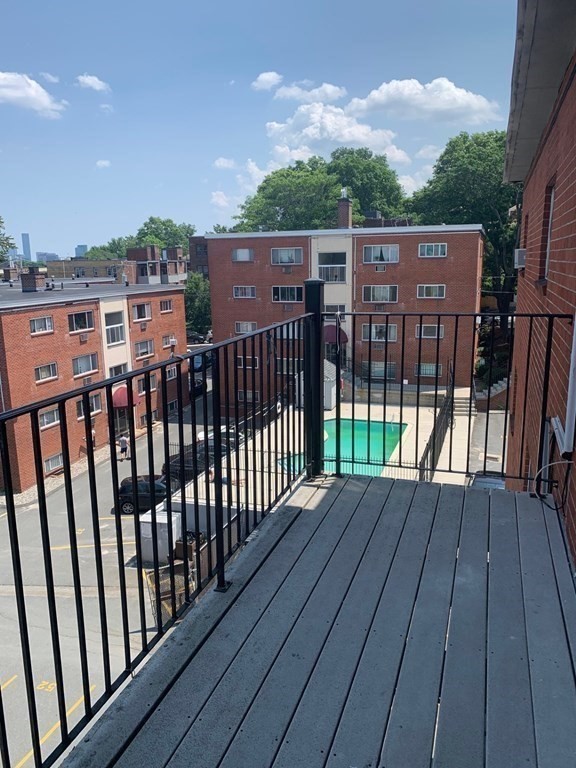36 Bellvista Road, Unit 47 Boston, MA 02135 - Photo 9 of 12 a view of deck with wooden floor and fence