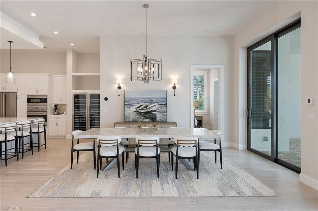 16776 Enclave Circle Naples, FL 34110 - Photo 12 of 50 a view of a a dining room with furniture window and wooden floor