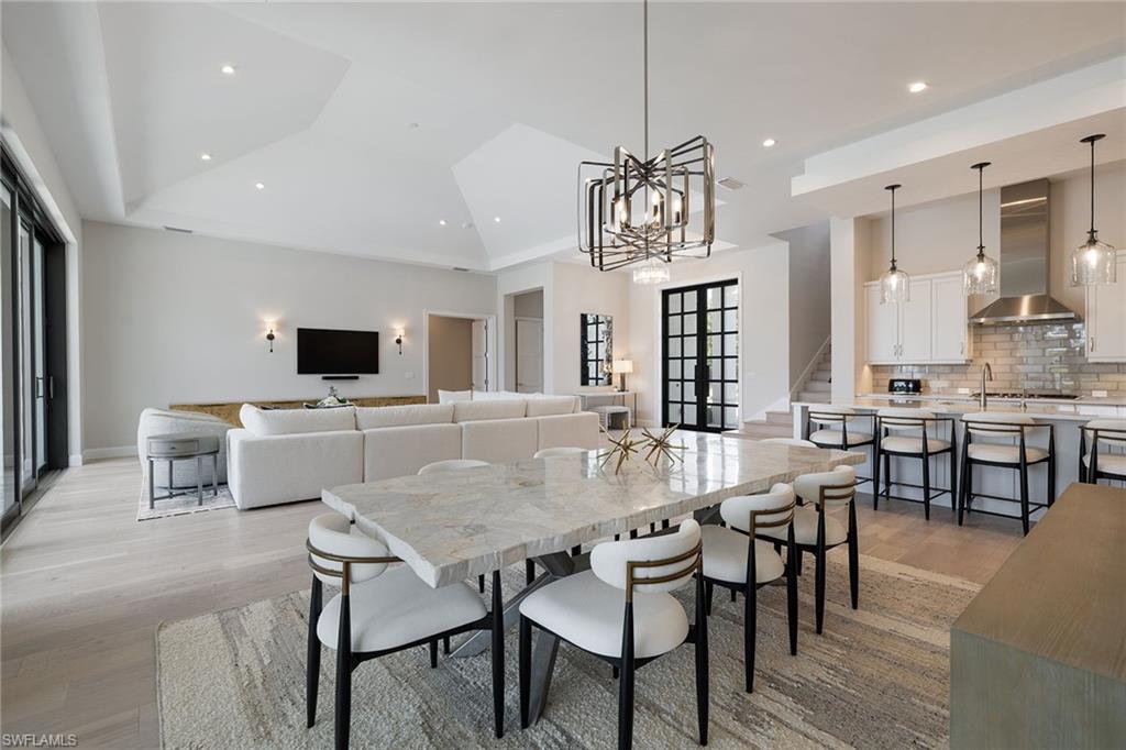 16776 Enclave Circle Naples, FL 34110 - Photo 13 of 50 a view of a dining room with furniture and wooden floor