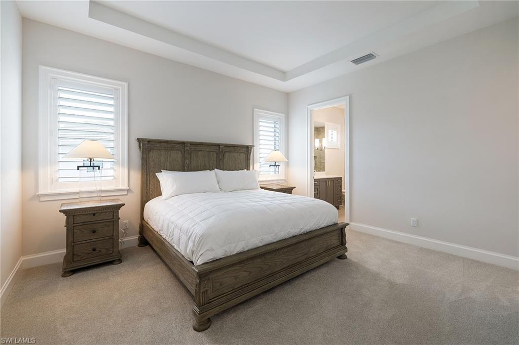 16776 Enclave Circle Naples, FL 34110 - Photo 16 of 50 a bed sitting in a bedroom next to a window