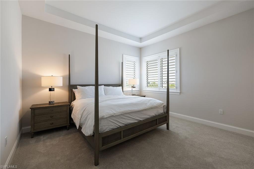 16776 Enclave Circle Naples, FL 34110 - Photo 19 of 50 a bedroom with a bed lamp and window