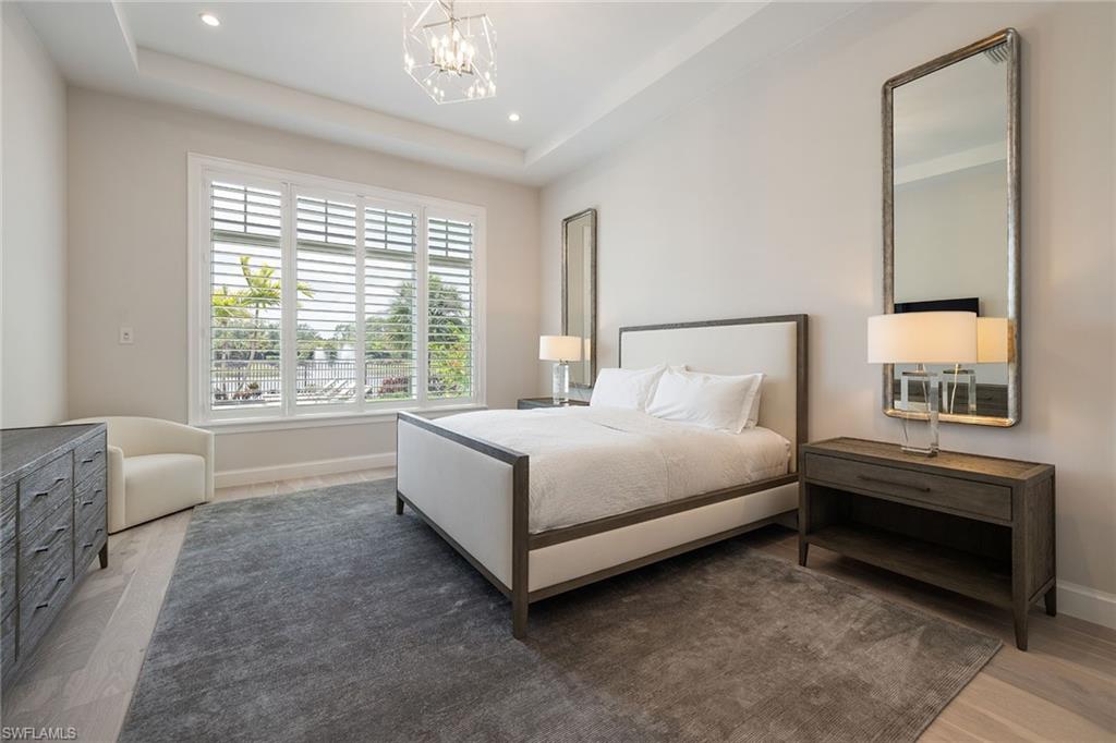 16776 Enclave Circle Naples, FL 34110 - Photo 21 of 50 a bed sitting in a bedroom next to a window