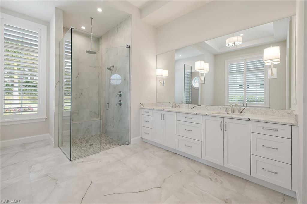 16776 Enclave Circle Naples, FL 34110 - Photo 24 of 50 a spacious bathroom with double sink shower and mirror