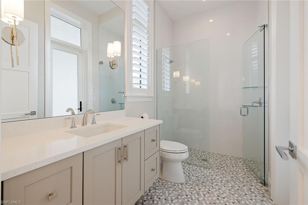 16776 Enclave Circle Naples, FL 34110 - Photo 26 of 50 a bathroom with a sink a toilet and shower
