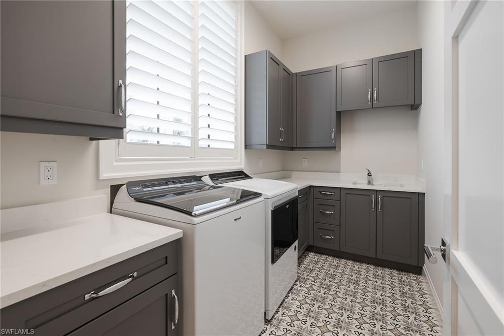 16776 Enclave Circle Naples, FL 34110 - Photo 27 of 50 a kitchen with a sink stove and cabinets