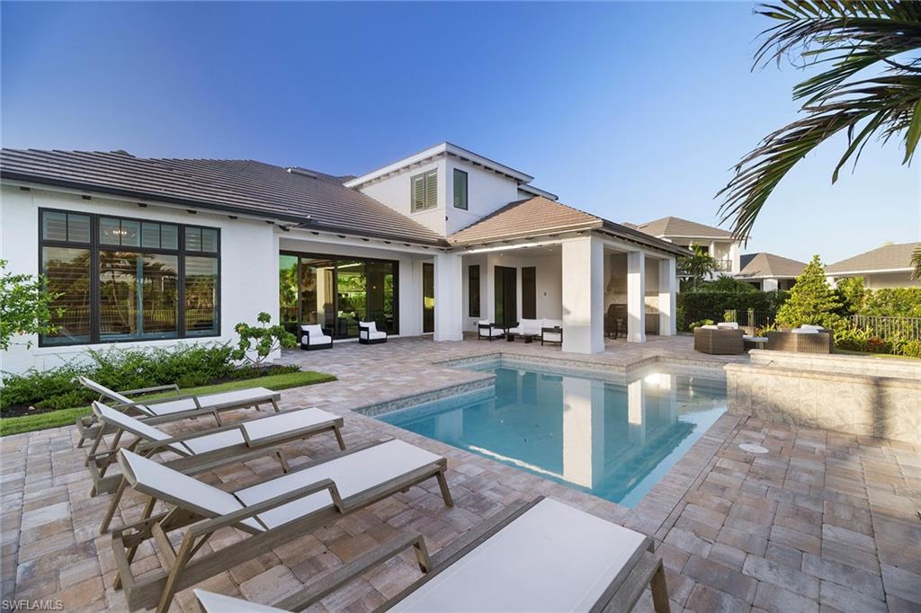 16776 Enclave Circle Naples, FL 34110 - Photo 35 of 50 a view of a house with pool and chairs