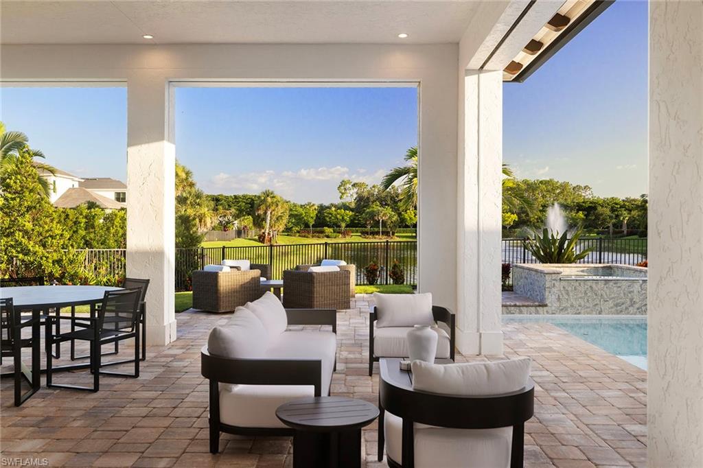 16776 Enclave Circle Naples, FL 34110 - Photo 36 of 50 a balcony with furniture and a floor to ceiling window
