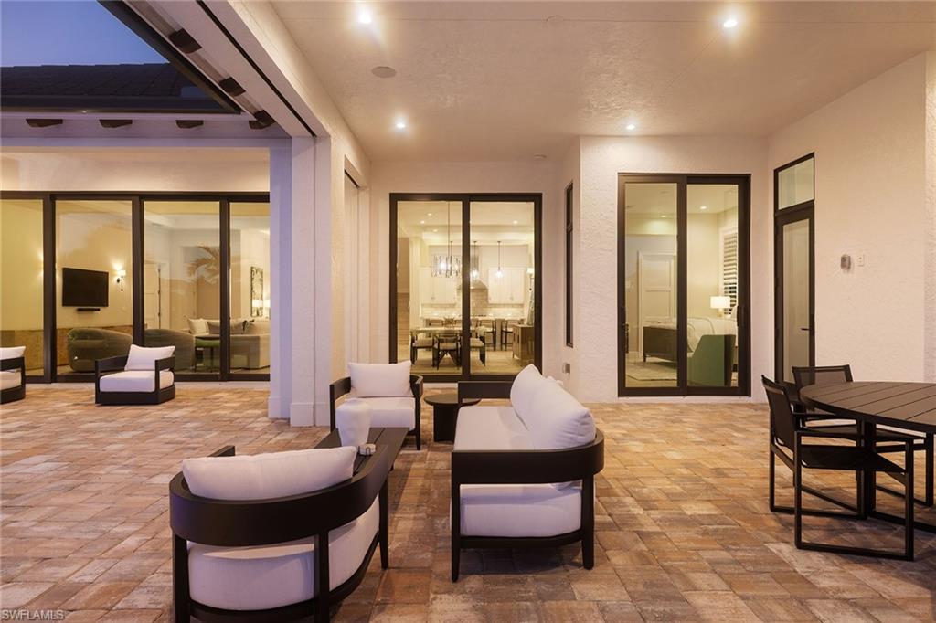 16776 Enclave Circle Naples, FL 34110 - Photo 42 of 50 a living room with furniture and floor to ceiling windows