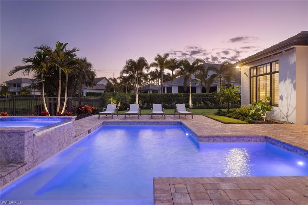 16776 Enclave Circle Naples, FL 34110 - Photo 44 of 50 a swimming pool with outdoor seating and yard