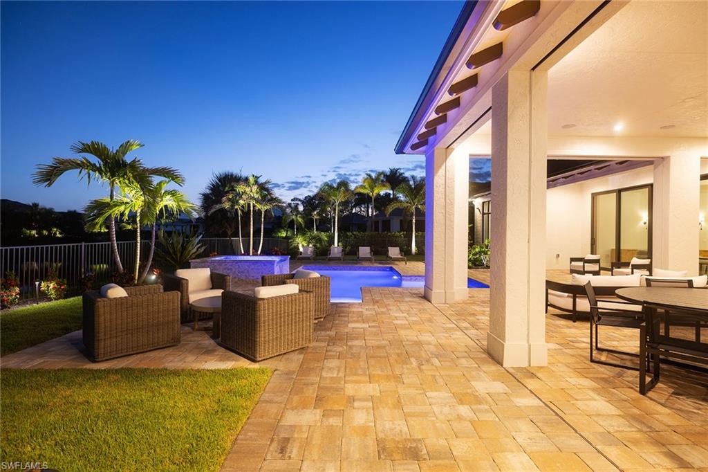 16776 Enclave Circle Naples, FL 34110 - Photo 46 of 50 a view of a patio with swimming pool and sitting area