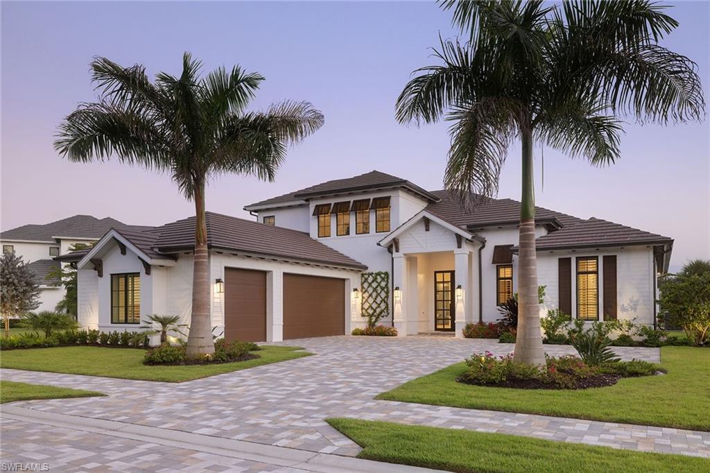 16776 Enclave Circle Naples, FL 34110 - Photo 49 of 50 front view of a house with a yard and palm trees