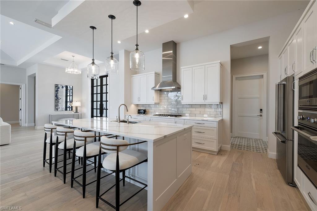 16776 Enclave Circle Naples, FL 34110 - Photo 6 of 50 a large kitchen with a table and chairs