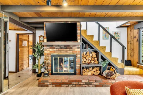 a living room with large window and couch