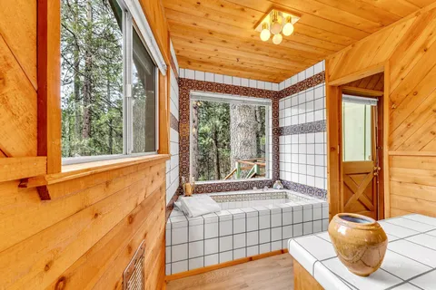 a bedroom with a bed and a large window