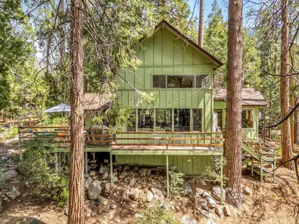 a backyard of a house with wooden fence and floor