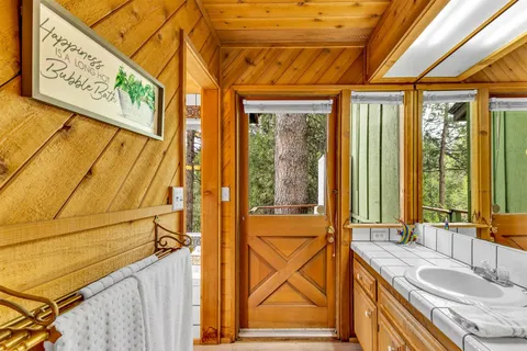 a view of backyard with seating space and wooden floor