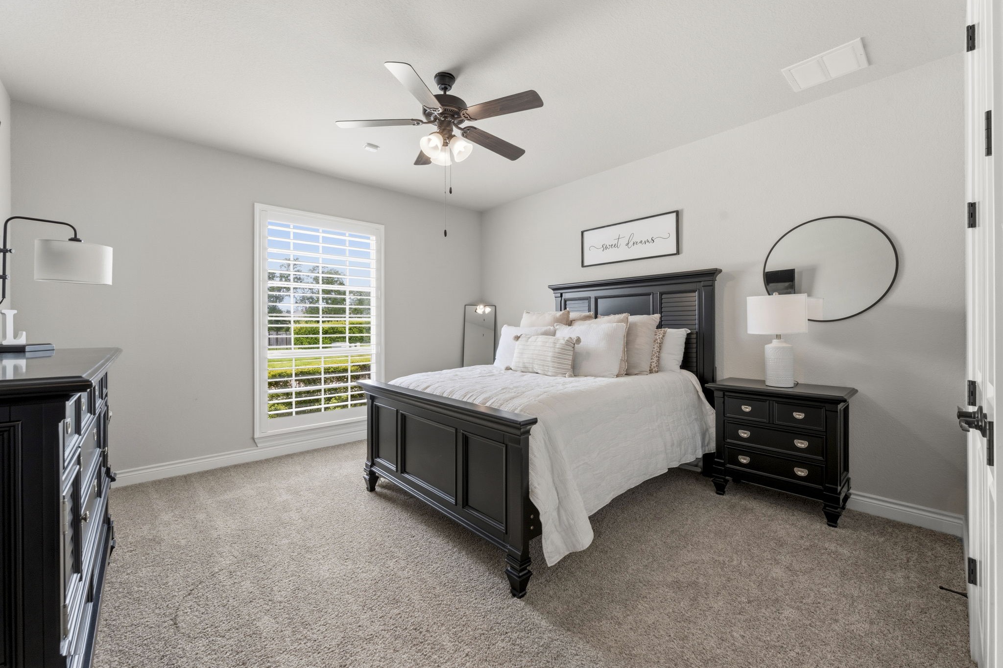 14012 Beartooth Bend Trail Conroe, TX 77384 - Photo 25 of 50 This bedroom offers plush carpeting, large walk-in closet, sunny window with plantation shutters, and a lighted ceiling fan. It has hallway access to the full bath shared with Bedroom 2.