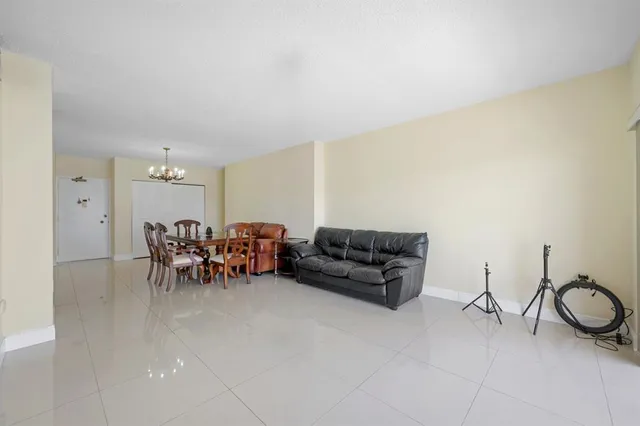 a living room with furniture and a dining table